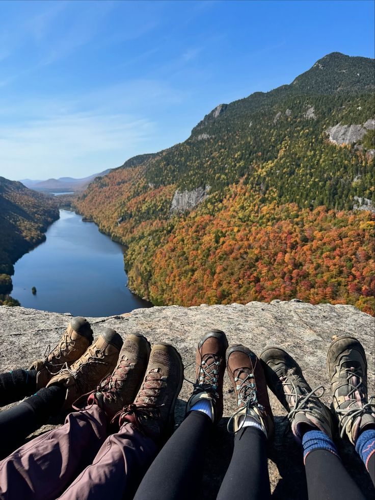 Hiking boots overlooking a mountain valley in fall